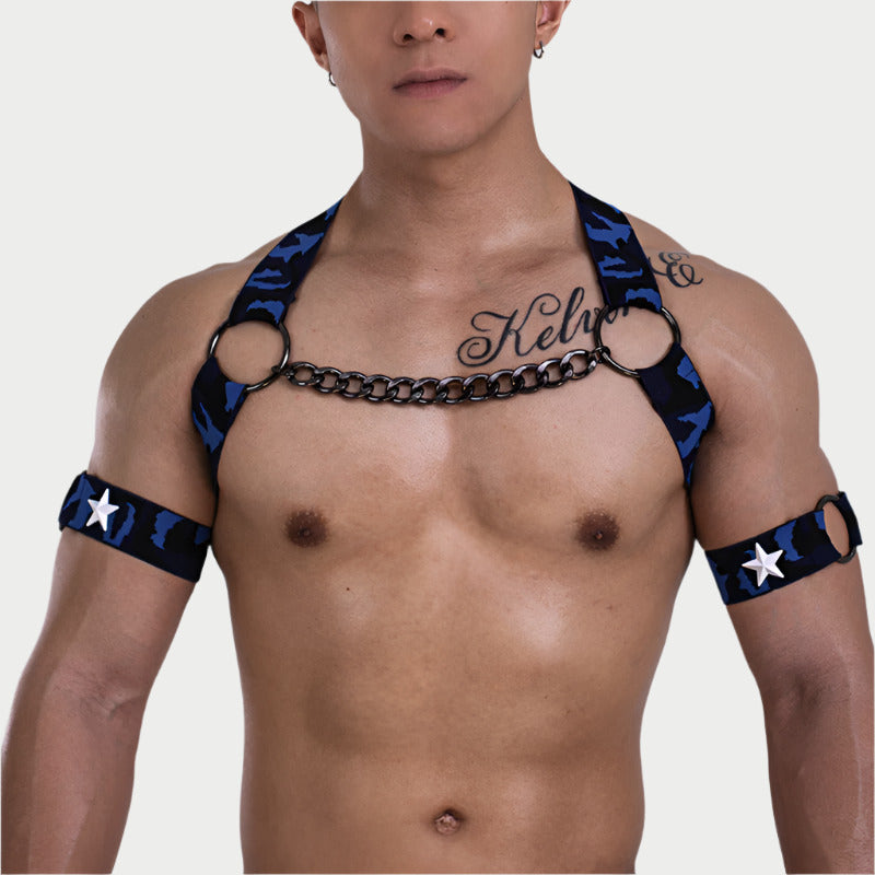 Man wearing a black and blue harness with star patterns on a plain background