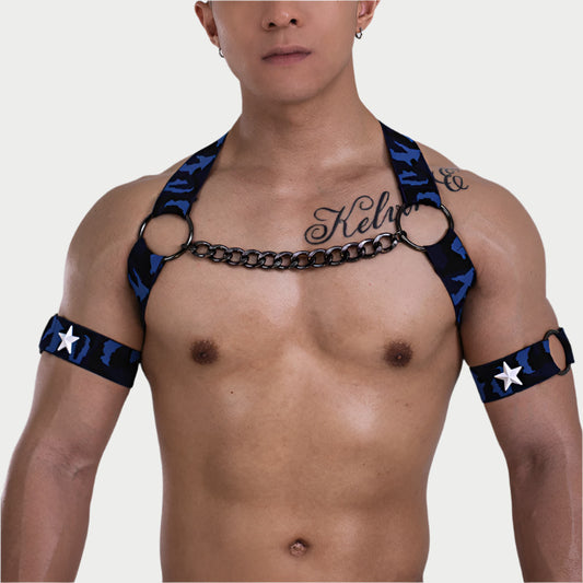 Man wearing a black and blue harness with star patterns on a plain background