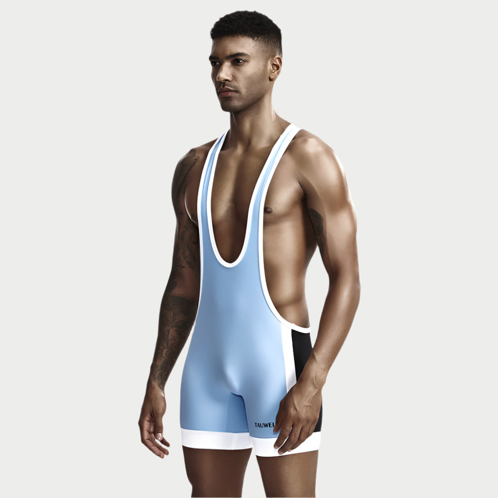 An athlete wearing a blue and red wrestling singlet with white trim, designed to be backless, with a solid color block pattern.