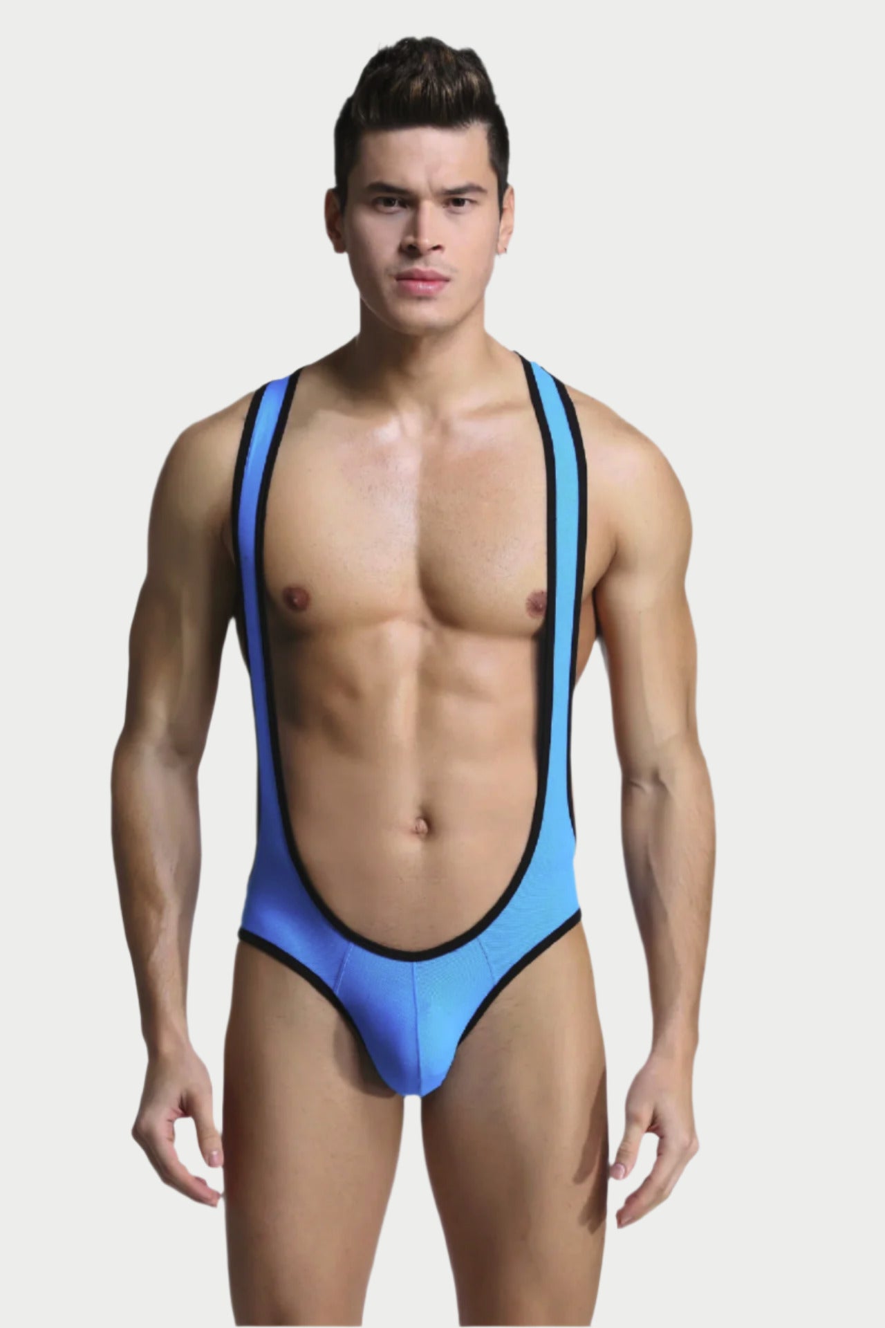 Man wearing a blue swimsuit with a plain background
