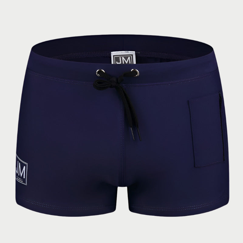Black swimming trunks with a drawstring waist and a front pocket, featuring a white logo on the left leg.