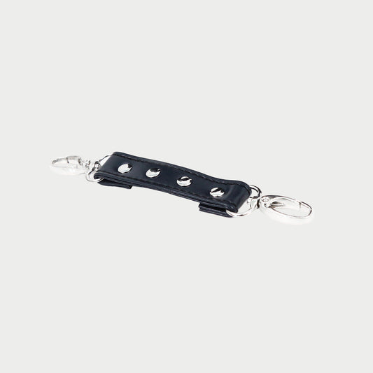 Black leather keychain with silver hardware on a white background