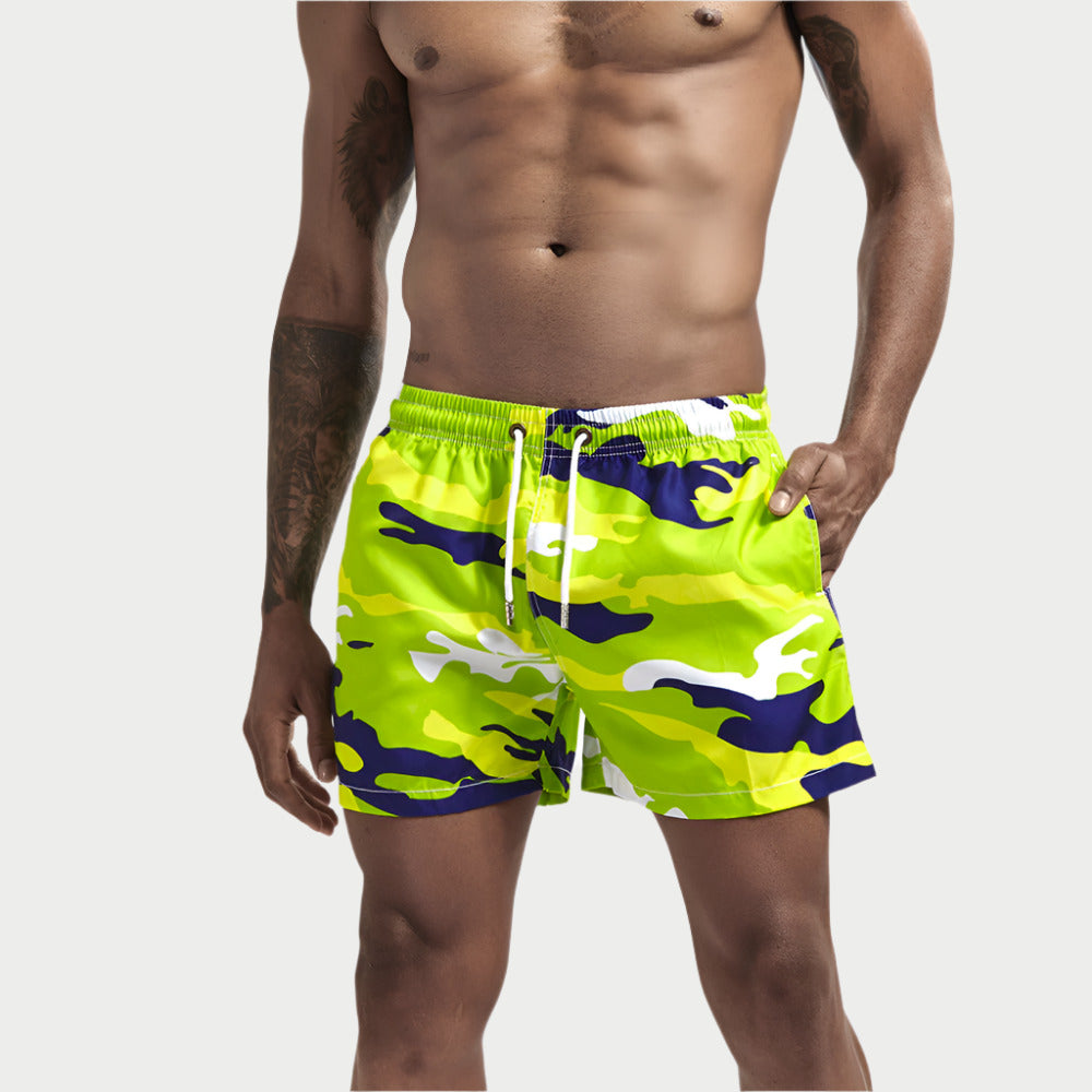 A person wearing camouflage patterned board shorts.