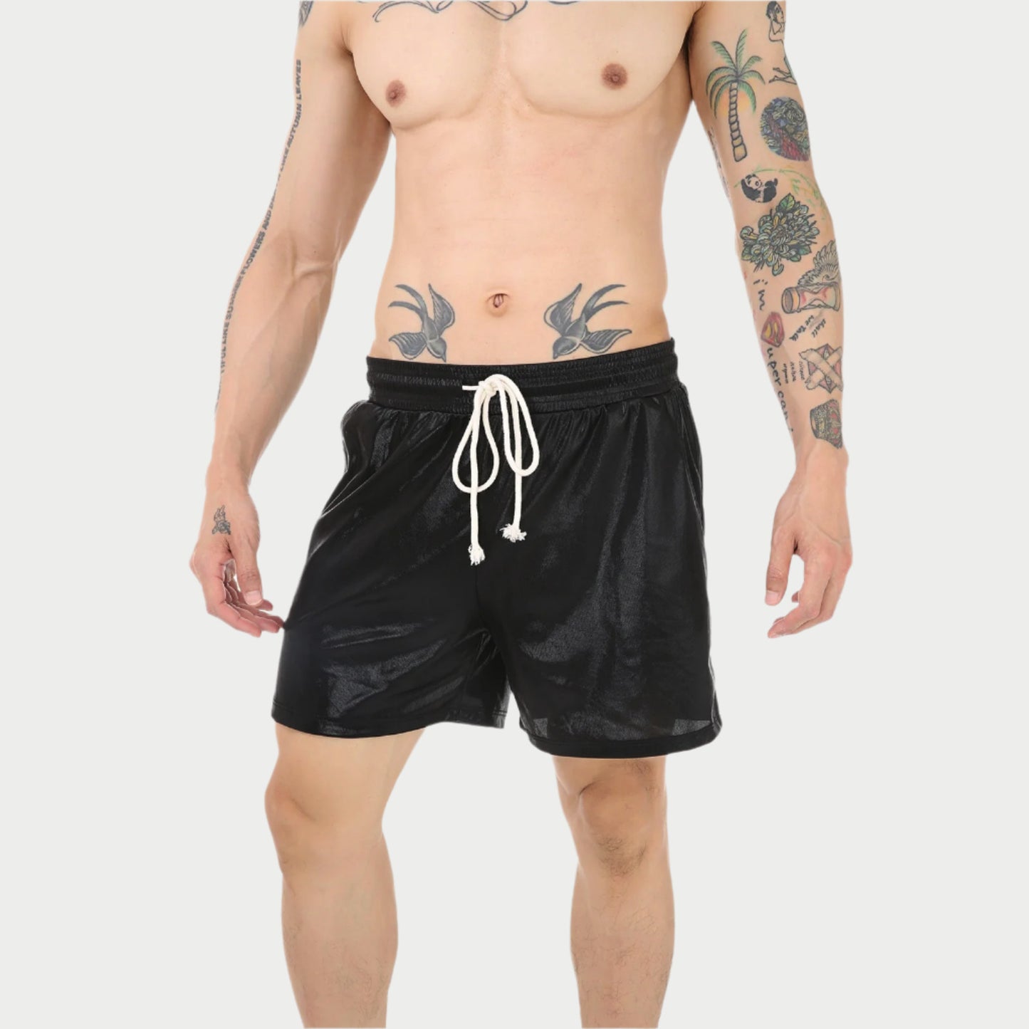 Man wearing black swim shorts with a white drawstring on a white background