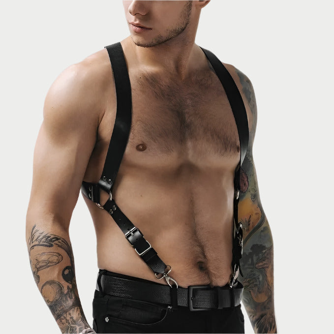 A person wearing a black faux leather adjustable suspender harness.