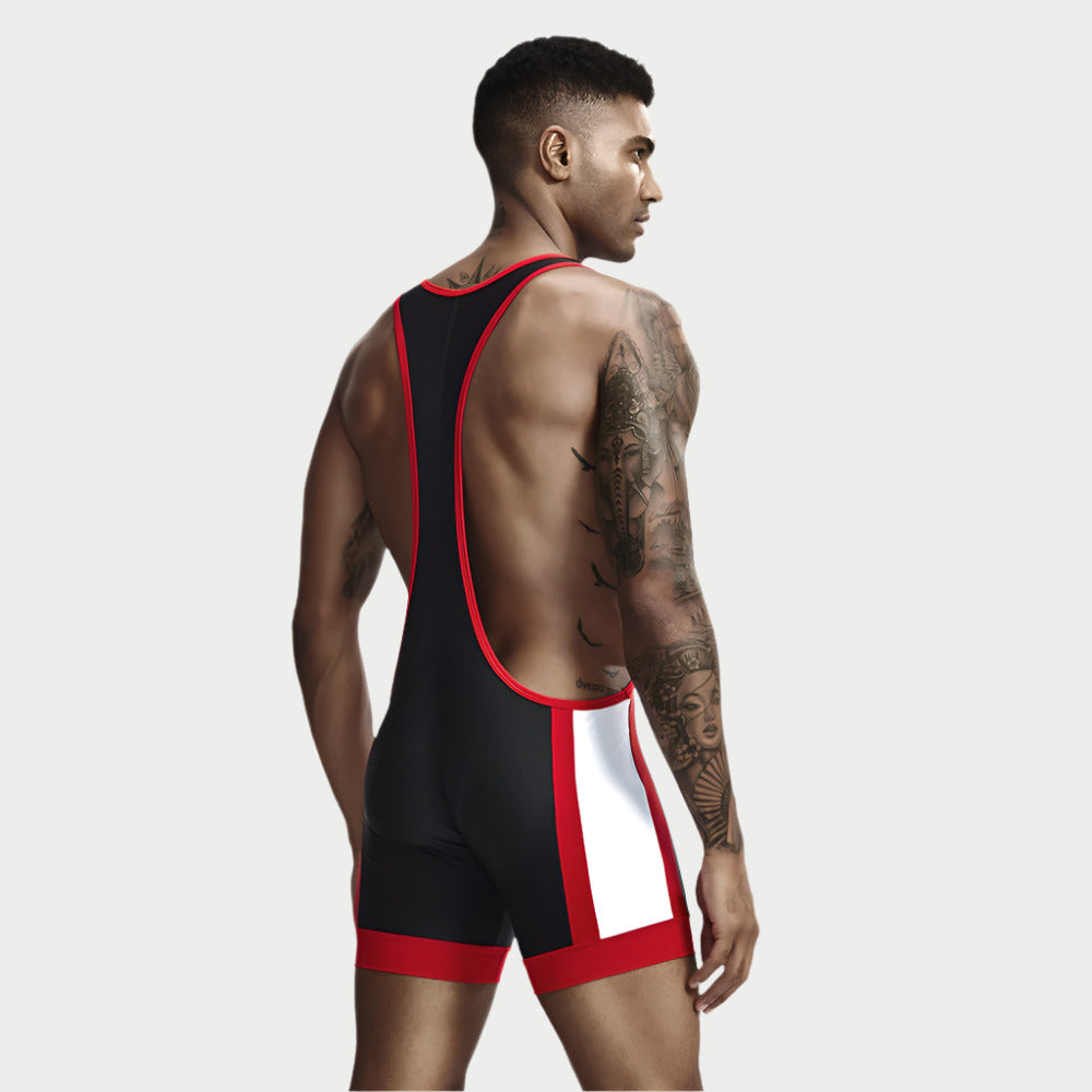 An athlete wearing a blue and red wrestling singlet with white trim, designed to be backless, with a solid color block pattern.