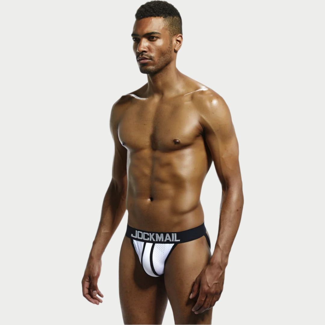 A model wearing a white mesh jockstrap with black trim and the brand name 'JOCKMAIL' visible on the waistband.