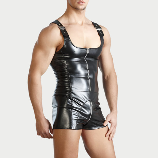 A person wearing a black faux leather bodysuit with shoulder straps and short length.