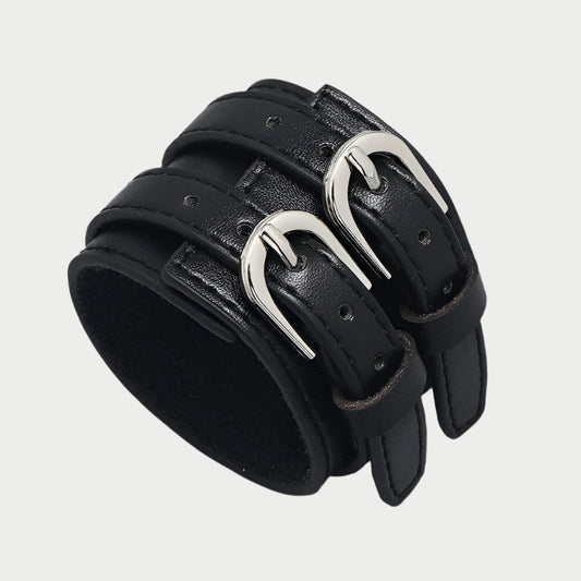 Adjustable black faux leather bracelet with two silver buckles.