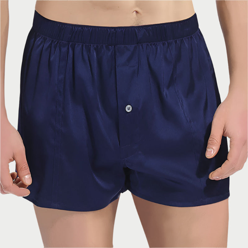 This image displays a pair of Mulberry Pure Silk Boxers, characterized by their sleek black color. The boxers are crafted from high-quality 100% Mulberry Silk, offering a luxurious softness and breathability that enhances comfort and soothes the skin.