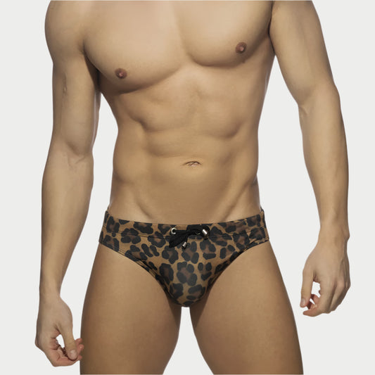 A model wearing leopard print swim briefs.