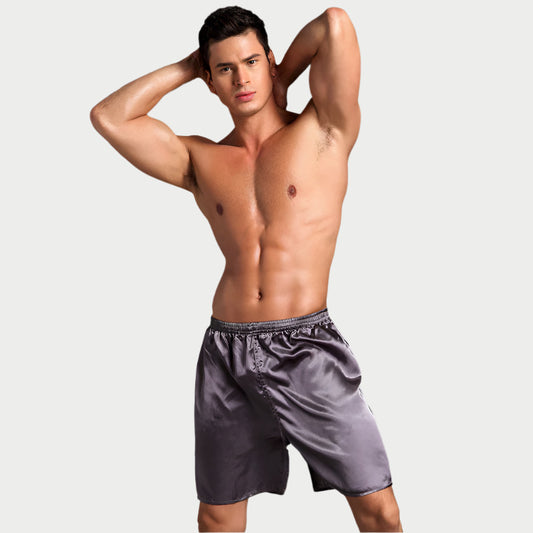 This image features a male model showcasing a pair of Classic Comfort Satin Boxers. The boxers are made from a high-quality, 100% polyester satin fabric, giving them a glossy and smooth appearance.