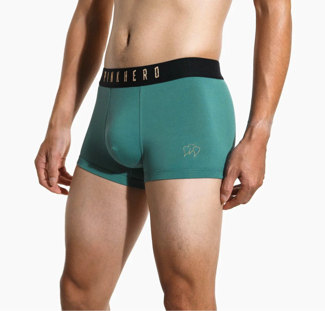 A pair of green bamboo trunk briefs with a branded elastic waistband, modeled by a person.