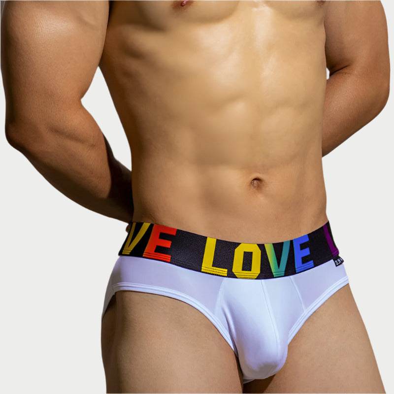 This image features a model wearing "LOVE Comfort Briefs" made of nylon. The briefs are white, providing a sleek and clean appearance.