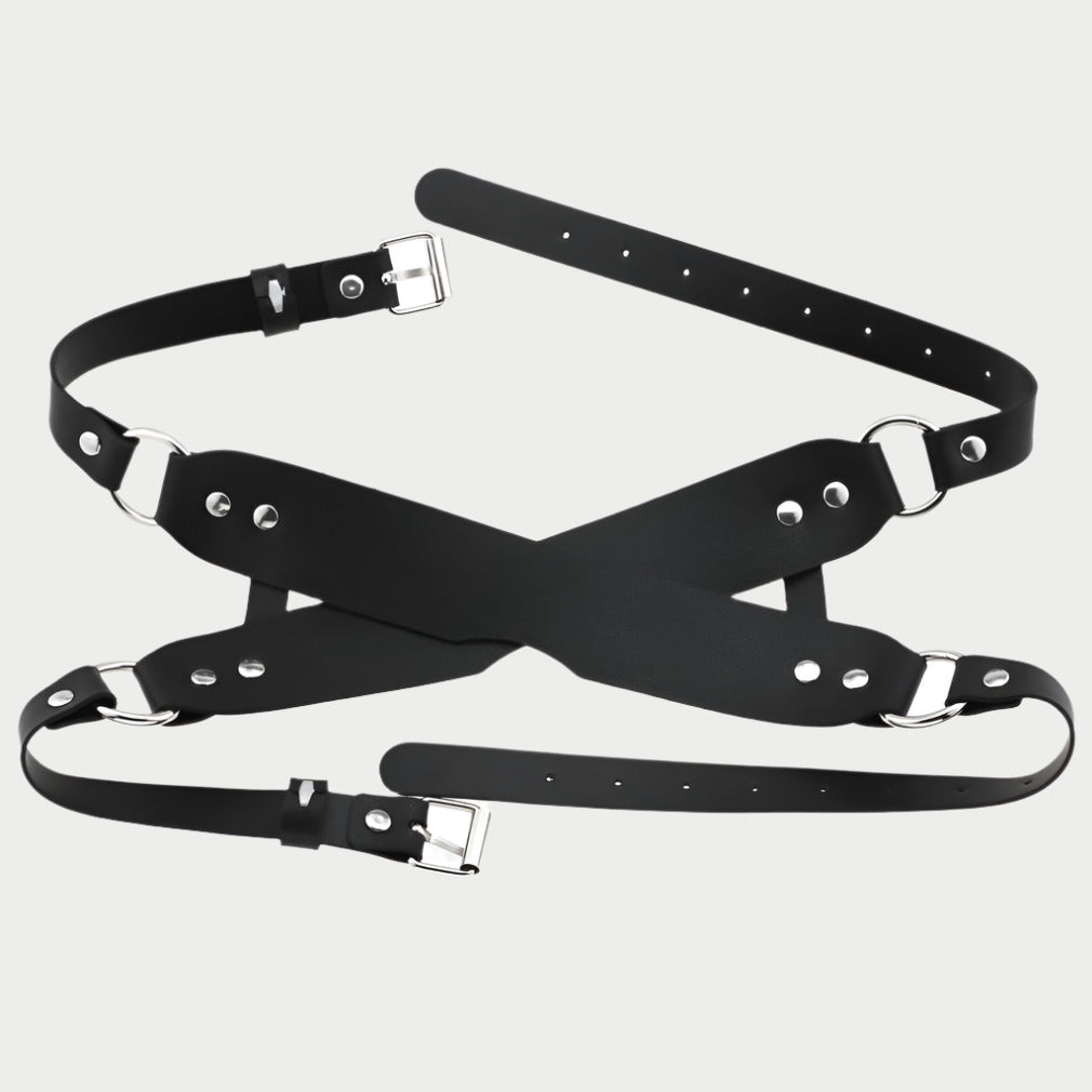 Black leather harness with metal buckles on a white background