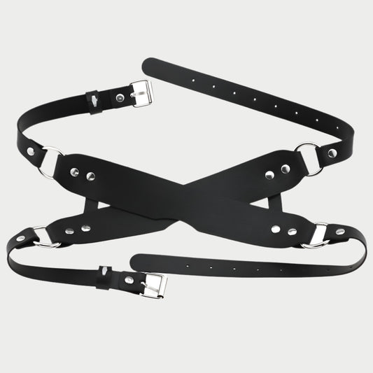 Black leather harness with metal buckles on a white background