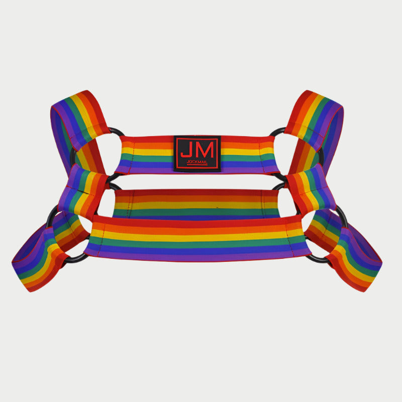 A rainbow-colored elastic harness with a black logo that reads 'JM' in the center