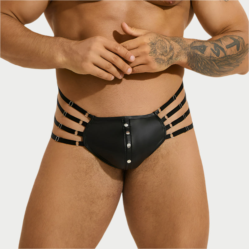 Black leather-style underwear with straps worn by a person on a white background
