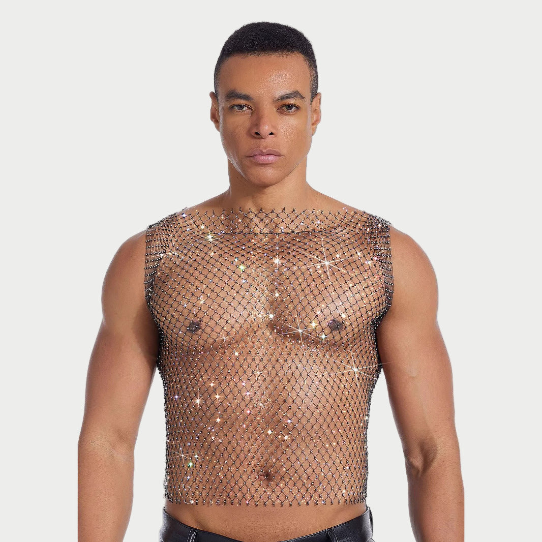 Man wearing a sparkly, fishnet top against a plain background