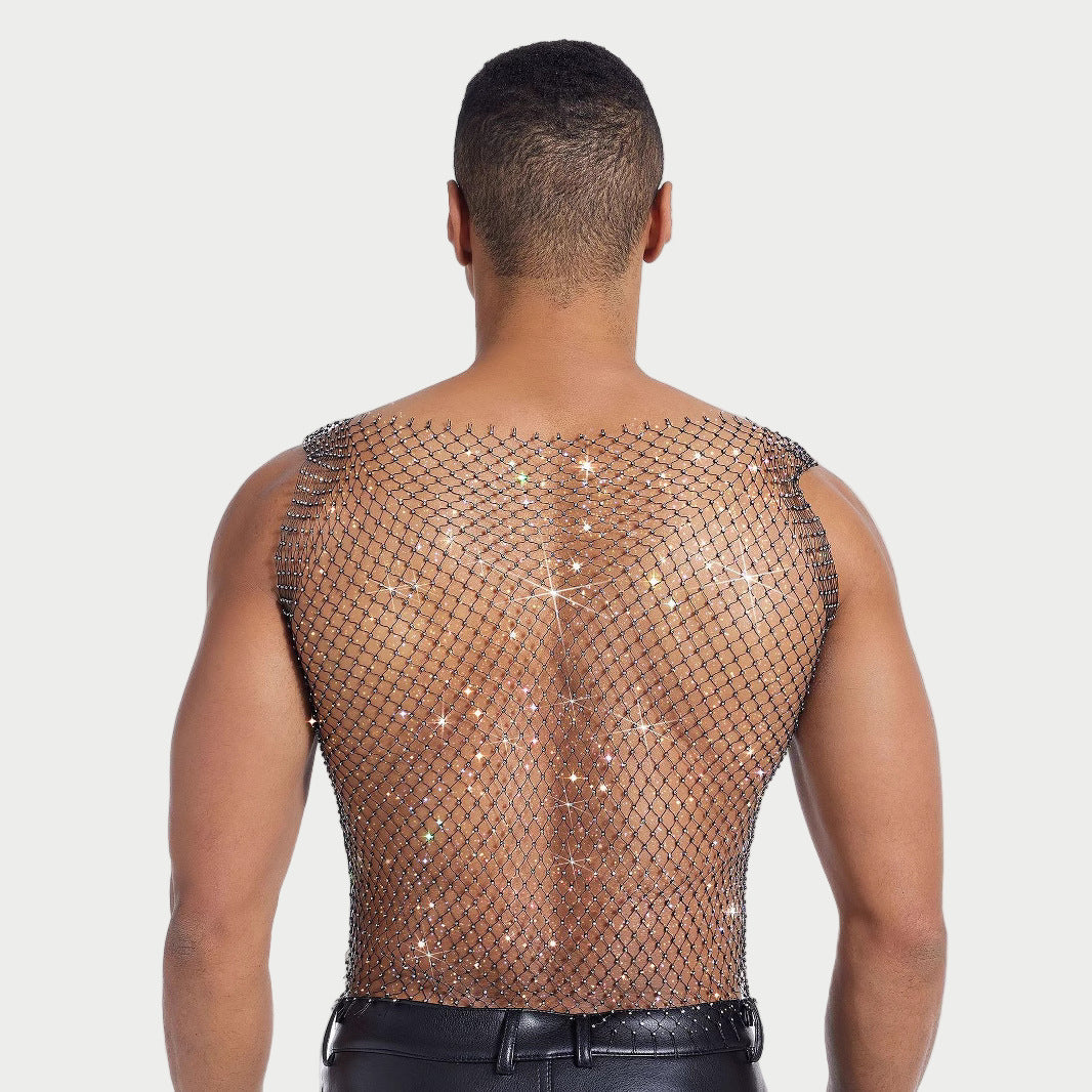 Person wearing a fishnet top with sparkling embellishments on a plain background