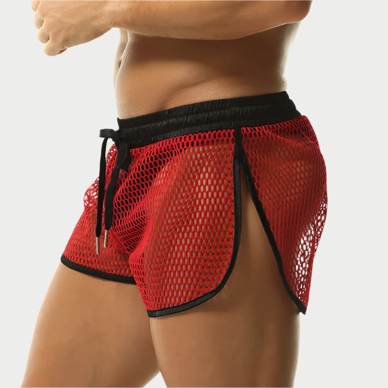 Red mesh shorts with black trim on a white background