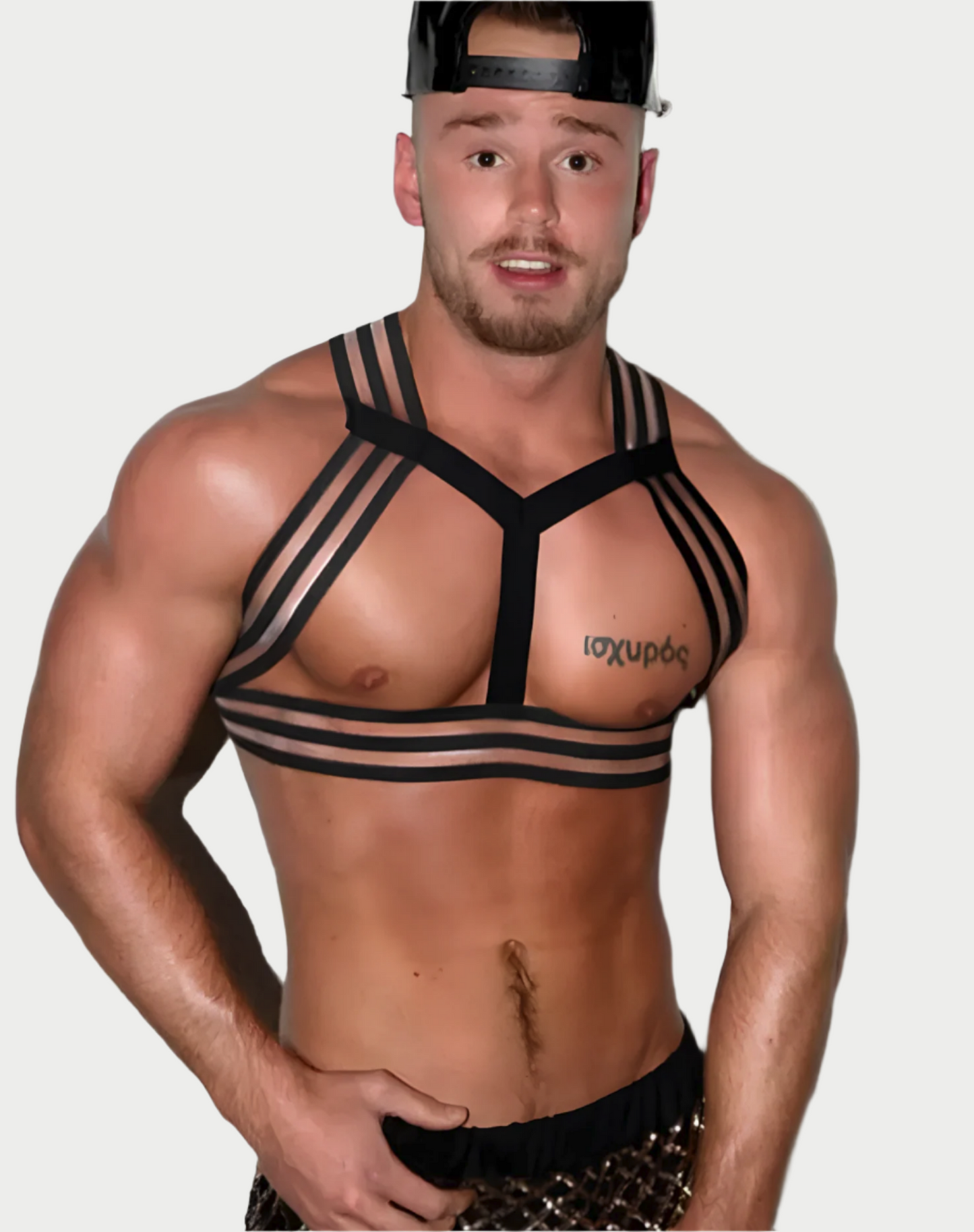 A person wearing a black and white striped elastic harness over a bare chest, with a cap on head.