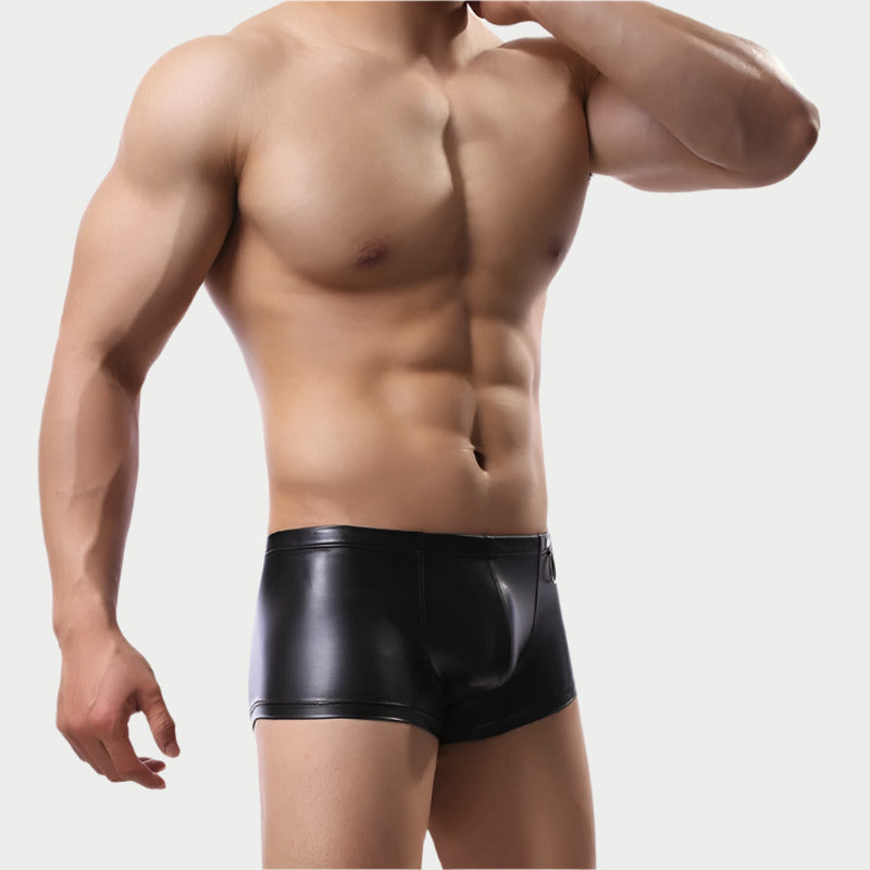 A model wearing black faux leather boxer briefs.