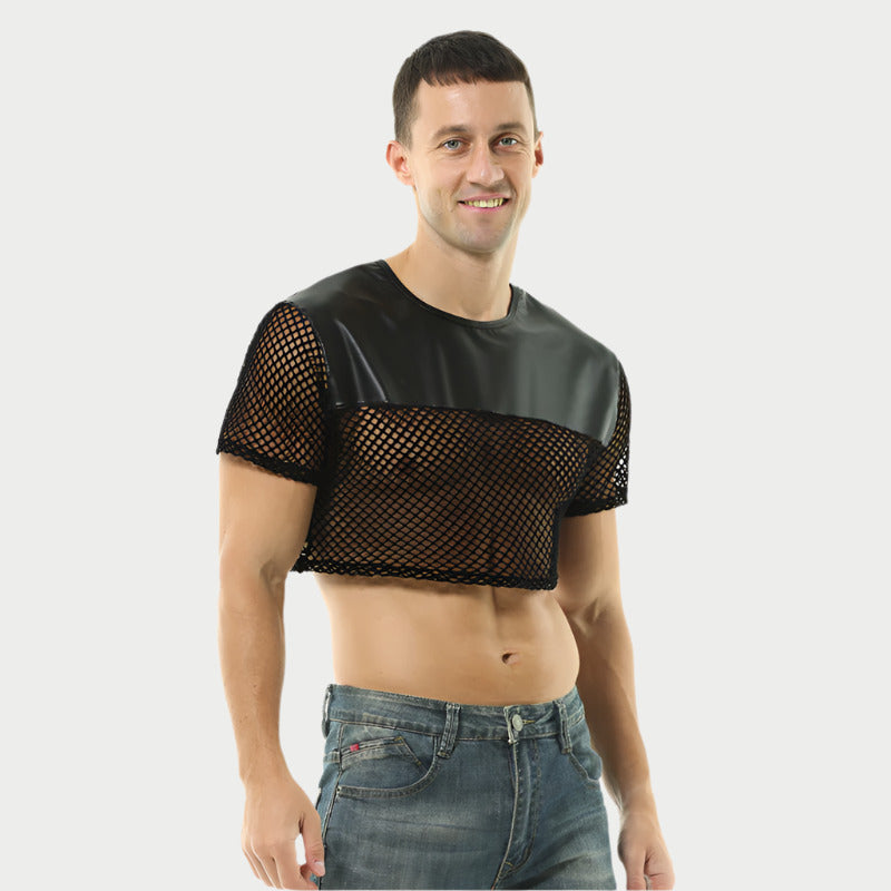 A man wearing a black leather mesh top with short sleeves and a V-neck design, paired with blue jeans.