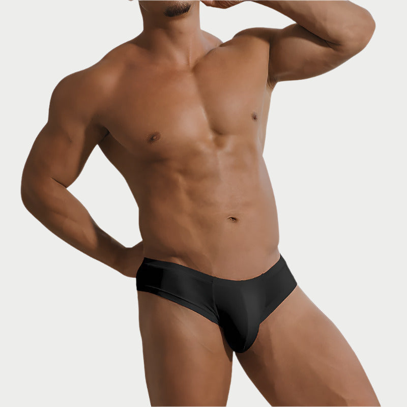 This image displays a model wearing "Essentials Breathable Briefs" made from modal fabric. The briefs are black and exhibit a sleek, snug fit emphasizing comfort and modern style.
