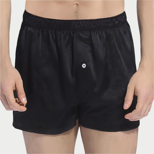 This image displays a pair of Mulberry Pure Silk Boxers, characterized by their sleek black color. The boxers are crafted from high-quality 100% Mulberry Silk, offering a luxurious softness and breathability that enhances comfort and soothes the skin.