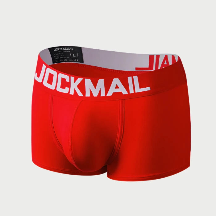 Red boxer briefs with 'Jockmail' waistband on a white background