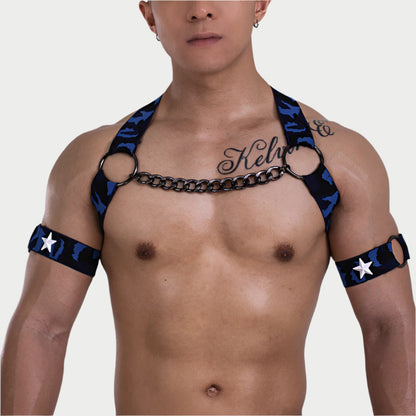 Man wearing a black and blue harness with star patterns on a plain background