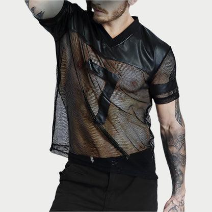 Person wearing a black mesh shirt with leather accents on a plain background